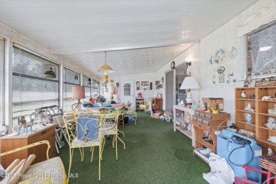 This 2 bedroom, 2 bath home with a covered carport wraps you in on High Point Golf Club, Inc. in Florida - for sale on GolfHomes.com, golf home, golf lot