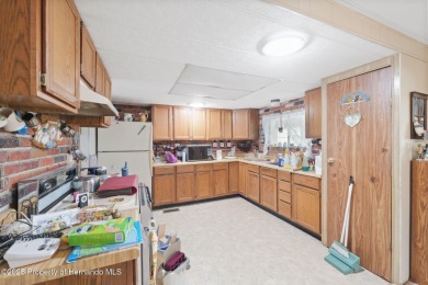 This 2 bedroom, 2 bath home with a covered carport wraps you in on High Point Golf Club, Inc. in Florida - for sale on GolfHomes.com, golf home, golf lot