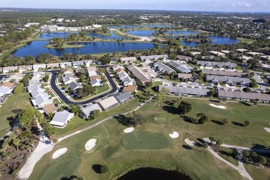 Nestled on a quiet street, this turnkey CBS townhouse has been on The Golf Club of Jupiter in Florida - for sale on GolfHomes.com, golf home, golf lot
