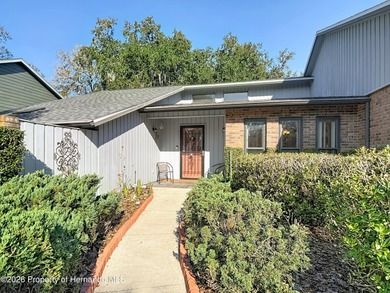 Welcome to your dream home in Whispering Oaks, where comfort on The Ridge Manor Oaks Golf and Country Club in Florida - for sale on GolfHomes.com, golf home, golf lot