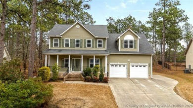 Enjoy outdoor living at its finest with a screened porch on Carolina Lakes Country Club in North Carolina - for sale on GolfHomes.com, golf home, golf lot