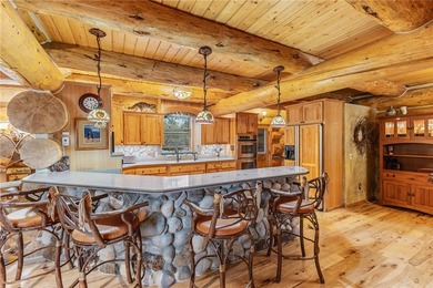An extraordinary log home surrounded by mature trees and on Red Lodge Golf Club in Montana - for sale on GolfHomes.com, golf home, golf lot