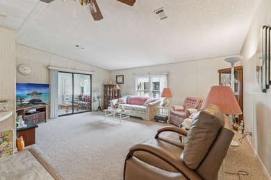 Welcome home to this well-loved, fully furnished 2-bedroom on Lake Henry Golf Club in Florida - for sale on GolfHomes.com, golf home, golf lot