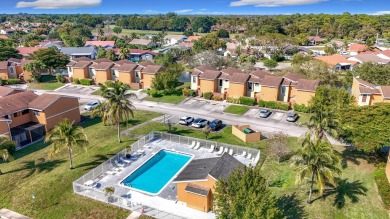 This beautifully renovated 2-bedroom, 2.5-bathroom townhouse on Woodmont Country Club in Florida - for sale on GolfHomes.com, golf home, golf lot