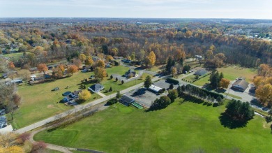 This stunning home situated on a well-manicured 1 acre lot is on Paw Paw Lake Golf Course in Michigan - for sale on GolfHomes.com, golf home, golf lot