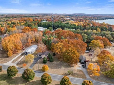 Classic bi-level looking over the 6th fairway of the Charlevoix on Charlevoix Golf Club in Michigan - for sale on GolfHomes.com, golf home, golf lot