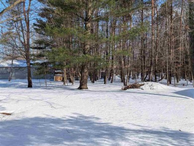 Classic bi-level looking over the 6th fairway of the Charlevoix on Charlevoix Golf Club in Michigan - for sale on GolfHomes.com, golf home, golf lot