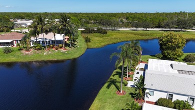 Rare corner-lot waterfront gem with wraparound water and golf on Savanna Golf Club in Florida - for sale on GolfHomes.com, golf home, golf lot