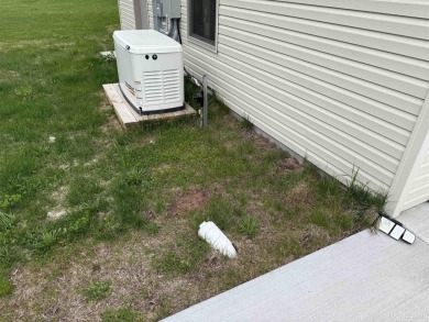 This is still like a brand new home! Seller bought in 2023 and on Portage Lake Golf Course in Michigan - for sale on GolfHomes.com, golf home, golf lot