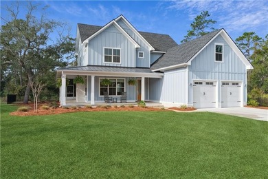 Welcome to this beautiful coastal-style home, tucked away in the on The Golf Club At Sanctuary Cove in Georgia - for sale on GolfHomes.com, golf home, golf lot