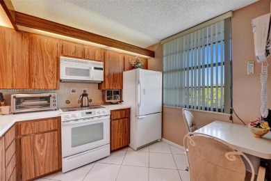 This 2 bedroom 2 bathroom 4th floor condo overlooking the golf on Pine Island Ridge Country Club in Florida - for sale on GolfHomes.com, golf home, golf lot