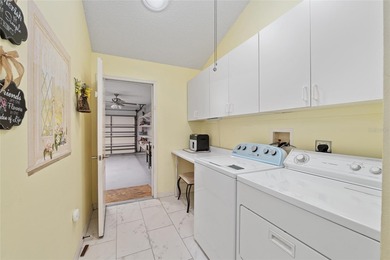 Nestled on a desirable corner homesite shaded by majestic live on Hacienda Hills Golf and Country Club in Florida - for sale on GolfHomes.com, golf home, golf lot