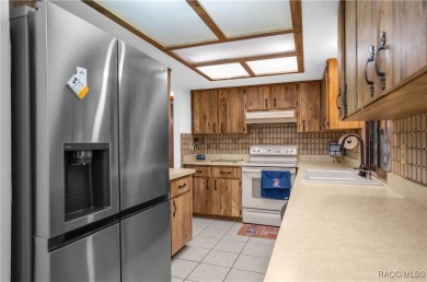 Discover this beautifully maintained 3-bedroom, 2-bathroom home on Sugarmill Woods Golf and Country Club in Florida - for sale on GolfHomes.com, golf home, golf lot