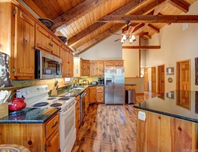 Discover your peaceful forest retreat in this inviting 3-bedroom on Cortez Golf Course in Arkansas - for sale on GolfHomes.com, golf home, golf lot