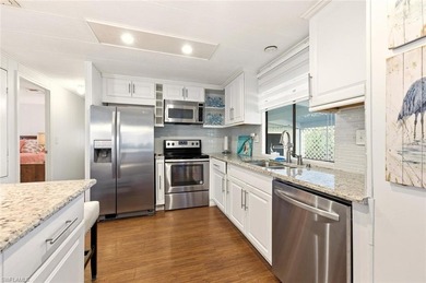 This polished home has updates throughout, a screened-in lanai on Riviera Golf Club in Florida - for sale on GolfHomes.com, golf home, golf lot