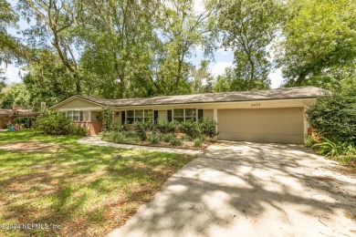 Nestled within a canopy of lush trees, this charming 1960s home on Blue Cypress Golf Club in Florida - for sale on GolfHomes.com, golf home, golf lot