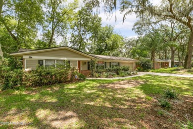 Nestled within a canopy of lush trees, this charming 1960s home on Blue Cypress Golf Club in Florida - for sale on GolfHomes.com, golf home, golf lot