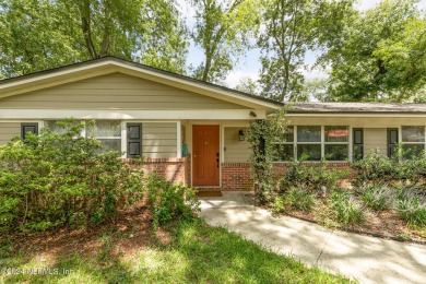 Nestled within a canopy of lush trees, this charming 1960s home on Blue Cypress Golf Club in Florida - for sale on GolfHomes.com, golf home, golf lot