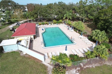 This charming home in the sought-after flower section of on Barefoot Bay Golf Course in Florida - for sale on GolfHomes.com, golf home, golf lot