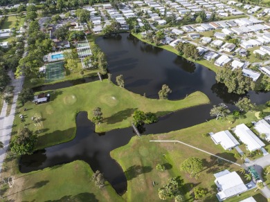 Beautiful CBC home backing to canal.  Magnificent landscaping on Spanish Lakes I in Florida - for sale on GolfHomes.com, golf home, golf lot
