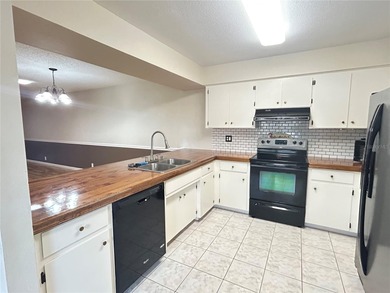 MOVE IN CONDITION!  Nestled on a beautifully landscaped and tree on Cypresswood Golf and Country Club in Florida - for sale on GolfHomes.com, golf home, golf lot