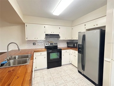 MOVE IN CONDITION!  Nestled on a beautifully landscaped and tree on Cypresswood Golf and Country Club in Florida - for sale on GolfHomes.com, golf home, golf lot