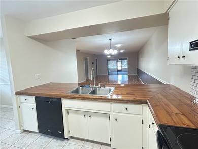 MOVE IN CONDITION!  Nestled on a beautifully landscaped and tree on Cypresswood Golf and Country Club in Florida - for sale on GolfHomes.com, golf home, golf lot