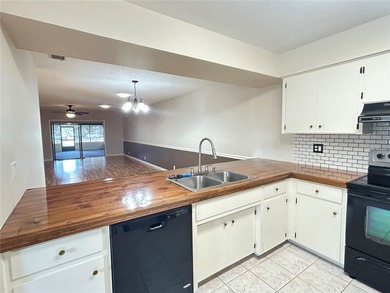 MOVE IN CONDITION!  Nestled on a beautifully landscaped and tree on Cypresswood Golf and Country Club in Florida - for sale on GolfHomes.com, golf home, golf lot