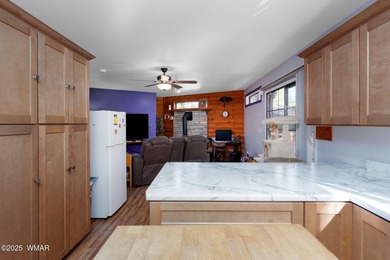 Tucked among towering pines, this inviting cabin offers the calm on Torreon Golf Club in Arizona - for sale on GolfHomes.com, golf home, golf lot