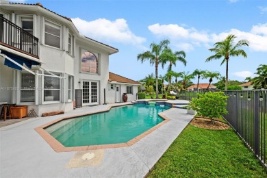Welcome to this luxurious home featuring soaring ceilings on Weston Hills Country Club in Florida - for sale on GolfHomes.com, golf home, golf lot