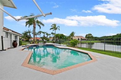 Welcome to this luxurious home featuring soaring ceilings on Weston Hills Country Club in Florida - for sale on GolfHomes.com, golf home, golf lot