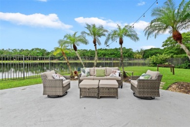 Welcome to this luxurious home featuring soaring ceilings on Weston Hills Country Club in Florida - for sale on GolfHomes.com, golf home, golf lot