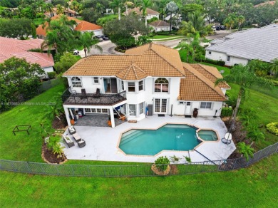 Welcome to this luxurious home featuring soaring ceilings on Weston Hills Country Club in Florida - for sale on GolfHomes.com, golf home, golf lot
