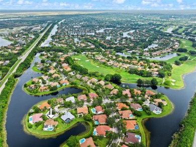 Welcome to this luxurious home featuring soaring ceilings on Weston Hills Country Club in Florida - for sale on GolfHomes.com, golf home, golf lot