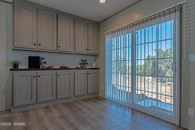 Step into this beautifully decorated, like-new 2024 home located on Silver Creek Golf Club in Arizona - for sale on GolfHomes.com, golf home, golf lot