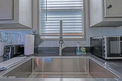 Step into this beautifully decorated, like-new 2024 home located on Silver Creek Golf Club in Arizona - for sale on GolfHomes.com, golf home, golf lot