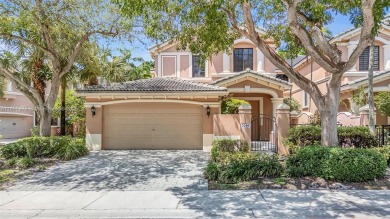 Spacious Coach Home with Golf Course Views in Weston Hills on Weston Hills Country Club in Florida - for sale on GolfHomes.com, golf home, golf lot