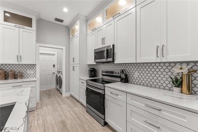 THIS IS LUXURY LIVING IN GATEWAY ! RENOVATED 4 BEDROOM AND 3 on Gateway Golf and Country Club in Florida - for sale on GolfHomes.com, golf home, golf lot