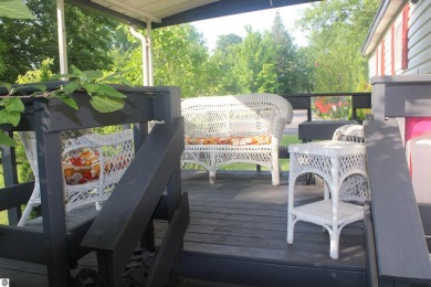 This beautifully maintained and recently updated home has 400 ft on Elk Rapids Golf Club in Michigan - for sale on GolfHomes.com, golf home, golf lot