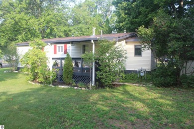 This beautifully maintained and recently updated home has 400 ft on Elk Rapids Golf Club in Michigan - for sale on GolfHomes.com, golf home, golf lot