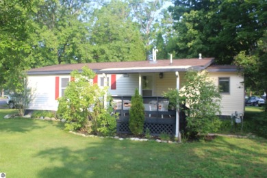 This beautifully maintained and recently updated home has 400 ft on Elk Rapids Golf Club in Michigan - for sale on GolfHomes.com, golf home, golf lot
