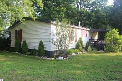 This beautifully maintained and recently updated home has 400 ft on Elk Rapids Golf Club in Michigan - for sale on GolfHomes.com, golf home, golf lot