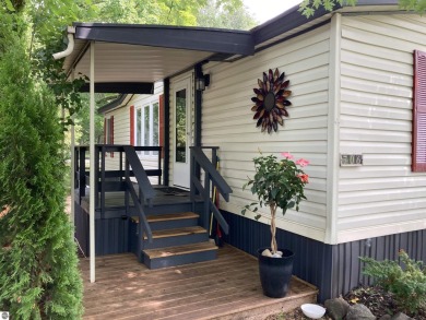 This beautifully maintained and recently updated home has 400 ft on Elk Rapids Golf Club in Michigan - for sale on GolfHomes.com, golf home, golf lot