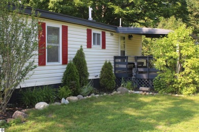 This beautifully maintained and recently updated home has 400 ft on Elk Rapids Golf Club in Michigan - for sale on GolfHomes.com, golf home, golf lot