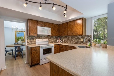 Escape to a peaceful, tree-lined oasis in this beautifully on Palm Harbor Golf Club in Florida - for sale on GolfHomes.com, golf home, golf lot