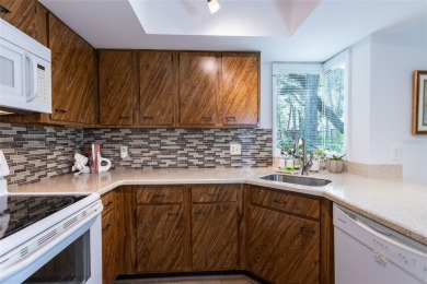 Escape to a peaceful, tree-lined oasis in this beautifully on Palm Harbor Golf Club in Florida - for sale on GolfHomes.com, golf home, golf lot