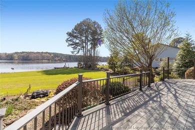 Stunning lakefront living awaits at 253 Lakeview Dr in the on Carolina Trace Country Club in North Carolina - for sale on GolfHomes.com, golf home, golf lot