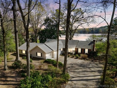 Stunning lakefront living awaits at 253 Lakeview Dr in the on Carolina Trace Country Club in North Carolina - for sale on GolfHomes.com, golf home, golf lot