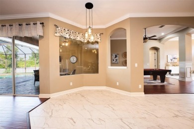 Stunning 4-Bedroom Pool Home with Office  Bonus Room in Gated on Heritage Isles Golf and Country Club in Florida - for sale on GolfHomes.com, golf home, golf lot