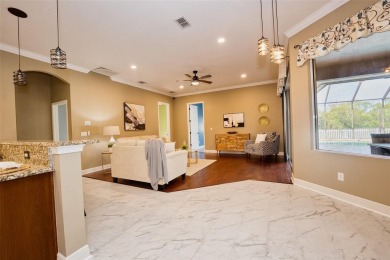 Stunning 4-Bedroom Pool Home with Office  Bonus Room in Gated on Heritage Isles Golf and Country Club in Florida - for sale on GolfHomes.com, golf home, golf lot